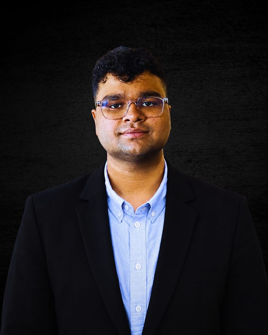Portrait of Arush Dubey in a black blazer and light blue shirt